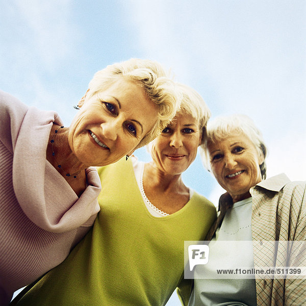 Three mature women  looking at camera  low angle view