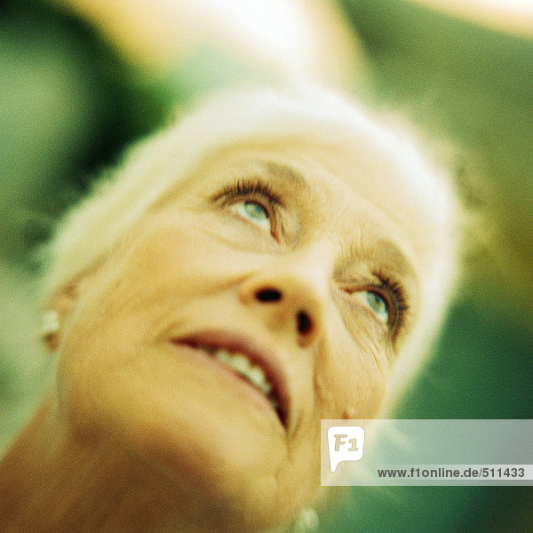 Portrait of senior woman looking up