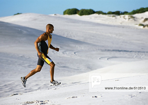 Man jogging on beach.