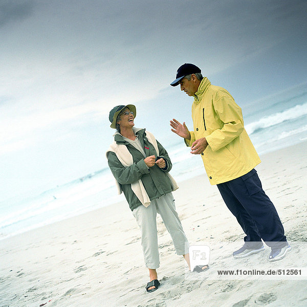 Mature couple talking on beach
