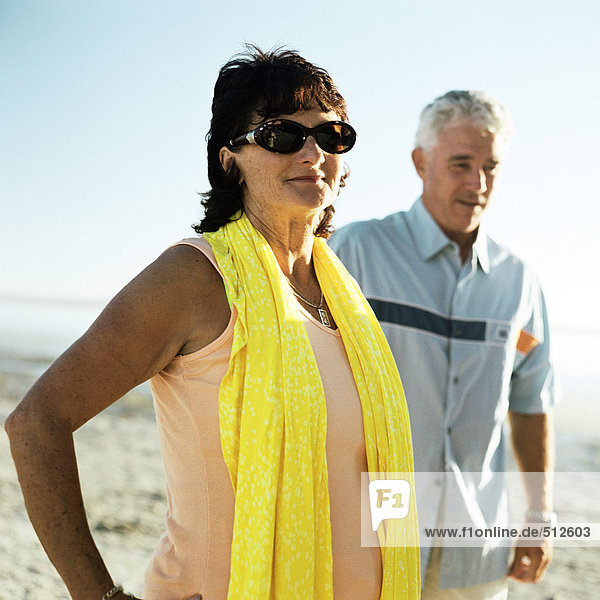 Mature couple standing on beach  portrait.
