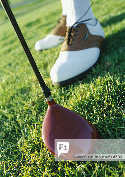 Golfer's feet and club  close-up
