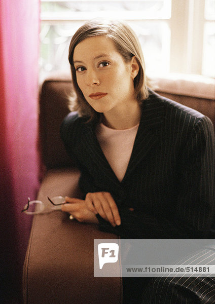 Woman sitting on sofa  portrait
