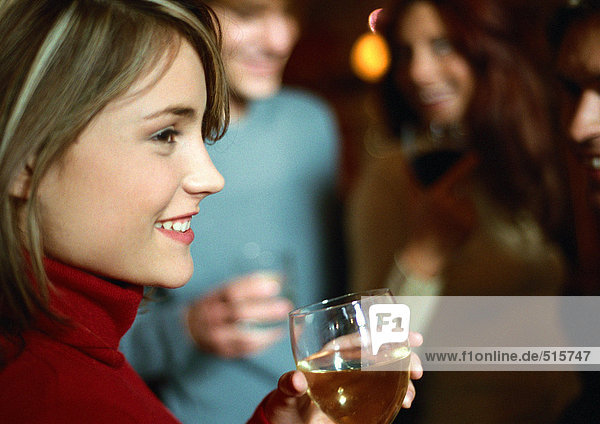 Woman drinking near group  close up