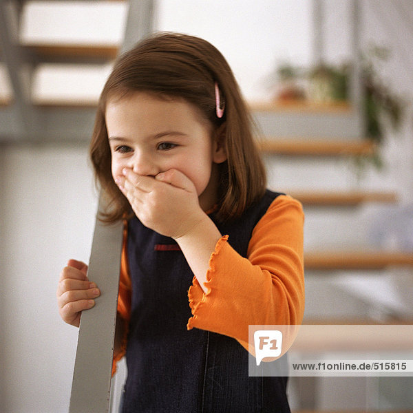 Young girl covering mouth with hand  portrait