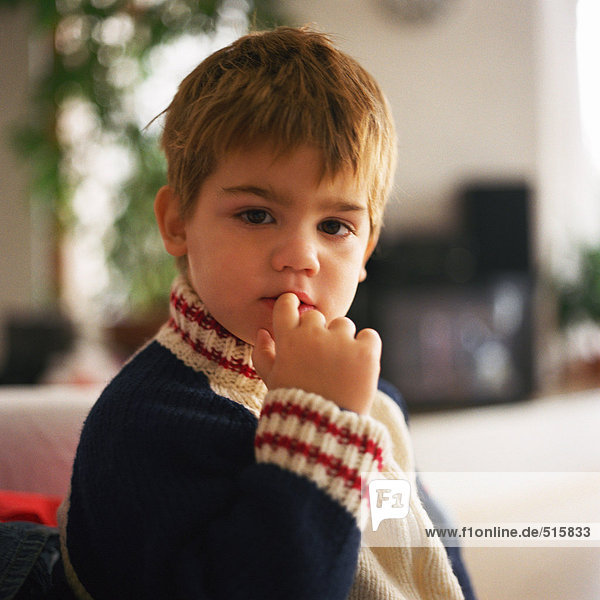 Young boy  finger in mouth  portrait