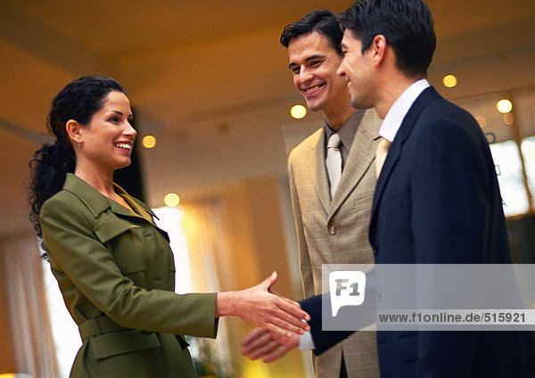Businesspeople  woman and man about to shake hands