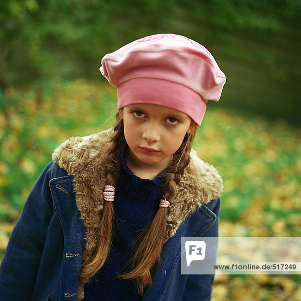 Girl outside wearing pink beret  winter coat  pouting  looking at camera