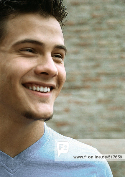 Teenage boy smiling looking away  close up portrait