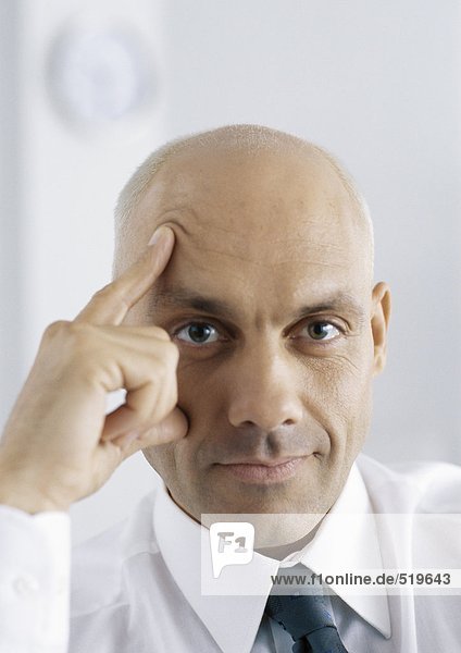 Businessman with fingers on face and forehead  portrait