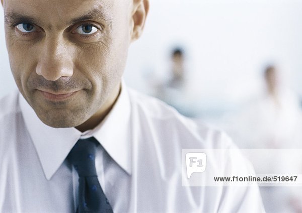 Businessman looking at camera with eyebrow raised