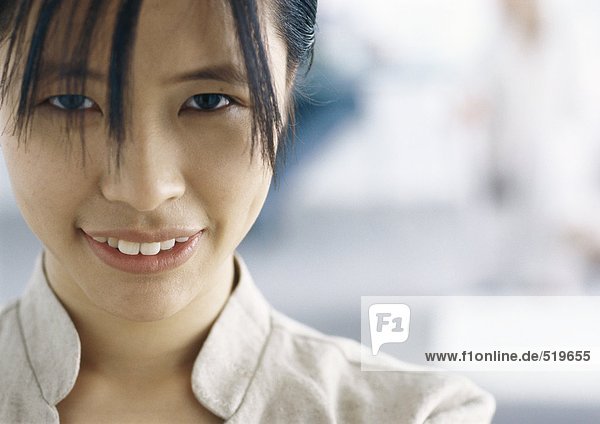 Young woman smiling at camera  close-up