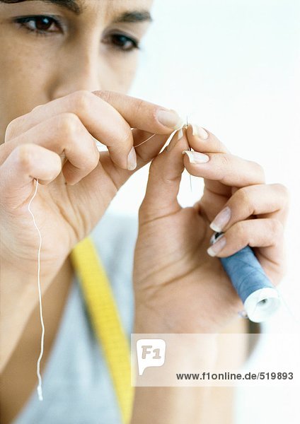 Woman threading needle