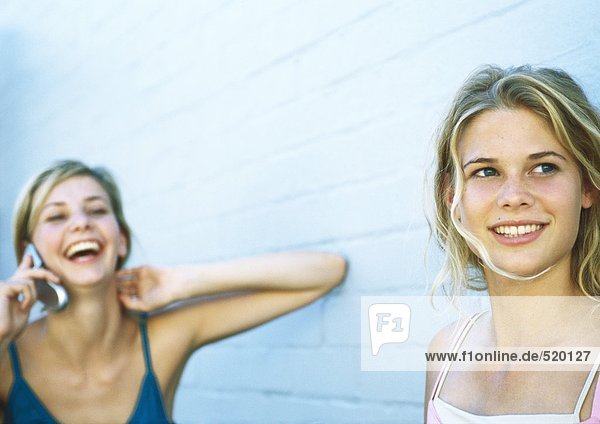Zwei Mädchen im Teenageralter  eine mit Handy