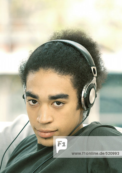 Young man listening to headphones  portrait