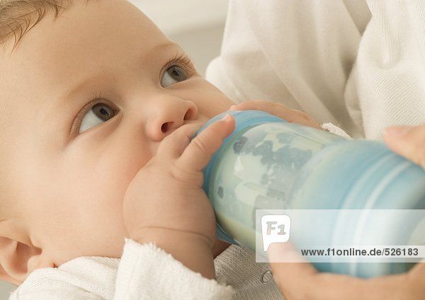 Baby drinking from bottle  close-up