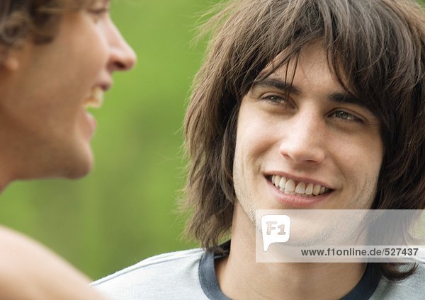 Young man listening to friend