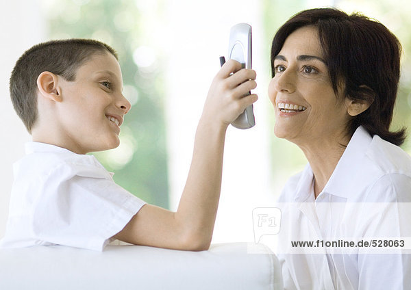 Boy showing grandmother cell phone