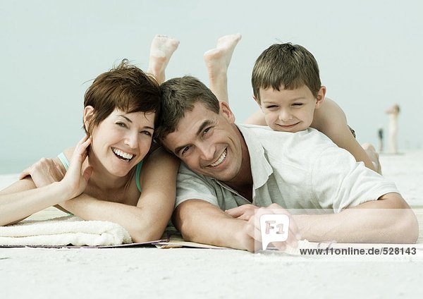 Family lying on beach  portrait