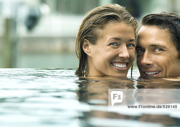 Paar lächelt im Pool