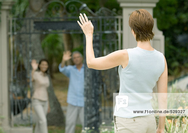 Woman waving to neighbors