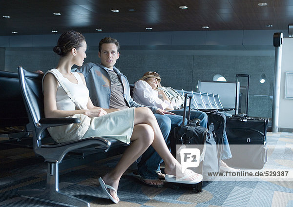 Travelers sitting in airport lounge