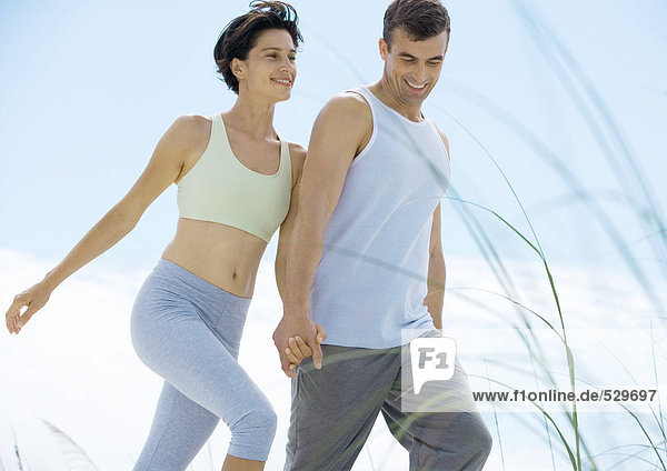 Couple walking in exercise clothes