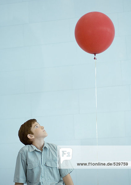 Junge schaut zum Ballon hinauf