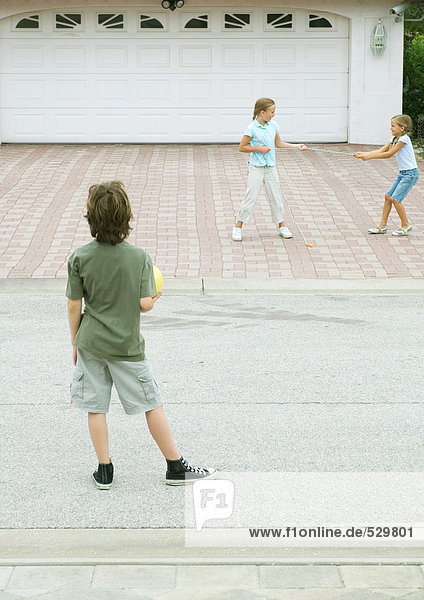 Suburban children playing in driveway
