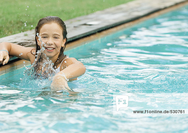 Little girl in swimming pool  splashing