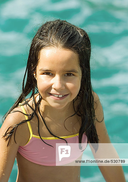 Girl in bathing suit  water in background  portrait