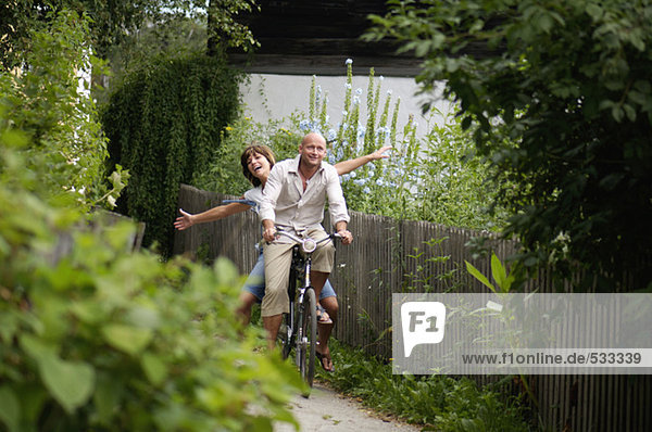 Couple riding bicycle  smiling