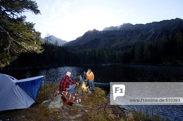 Man and woman camping at lake