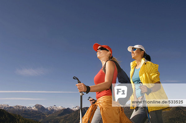 Two women in mountains  Nordic walking