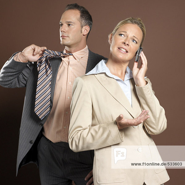 Businessman and businesswoman  woman holding mobile phone
