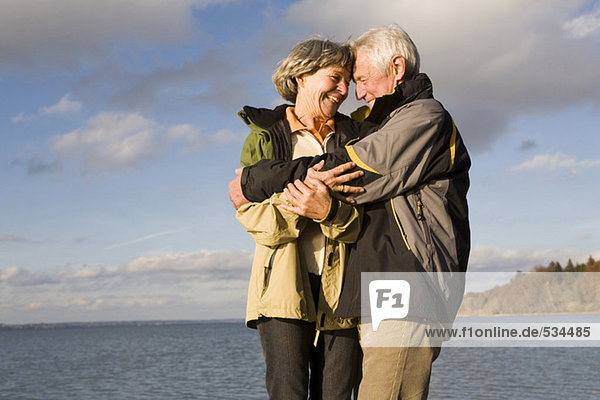 Senior couple embracing  smiling