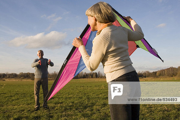 Germany Bavaria  Ammersee  Senior couple flying kite
