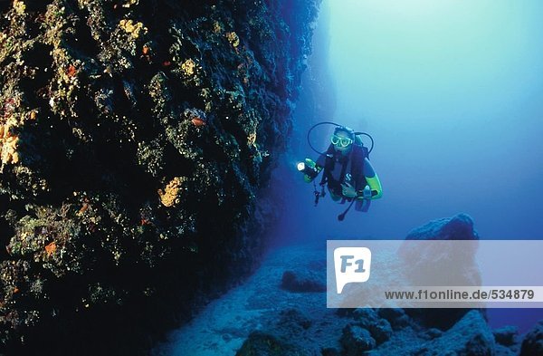 Scuba diver exploring under the sea  Grotto Cave  Corfu Island  Greece