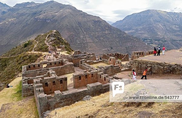 Tourists looking at old ruins  Inca Ruins  Machu Picchu  Cusco Region  Peru