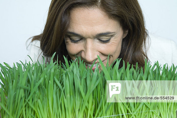 Woman smelling wheatgrass