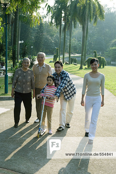 Three generation family walking in park