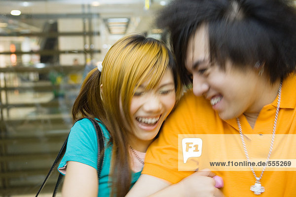 Teenage couple laughing  blurred motion