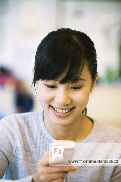 Woman looking at cell phone  smiling