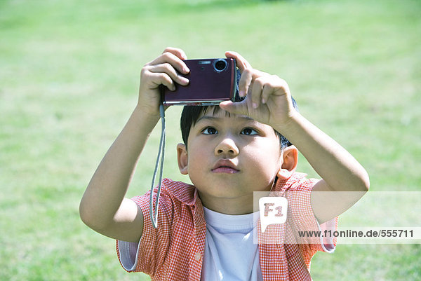 Boy using digital camera