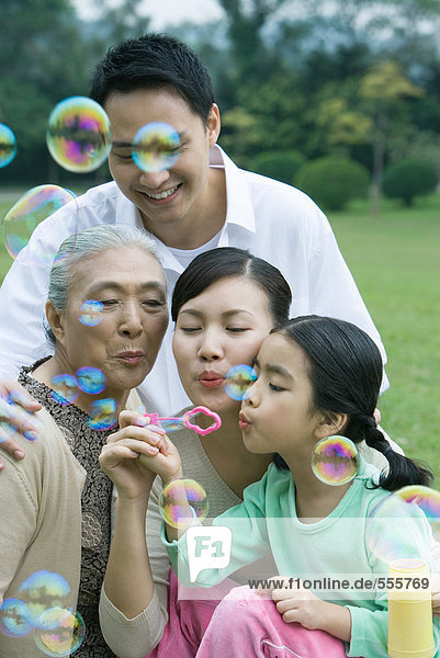 Drei-Generationen-Familie bläst Blasen