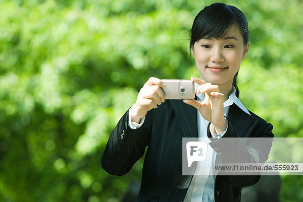 Woman taking photo with phone
