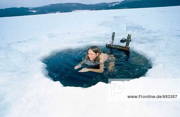 Hole in the ice  having a cold bath after the sauna. Jämtland  Sweden