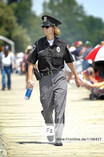 Police patrol boardwalk during boat races at St. Clair. Michigan  USA