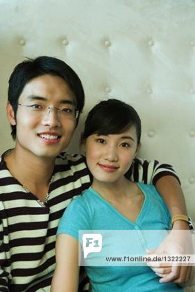 Young couple  man's arm around woman  portrait