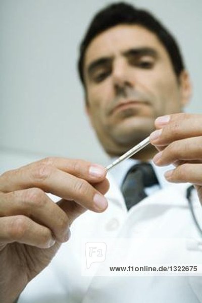 Doctor holding thermometer  low angle view